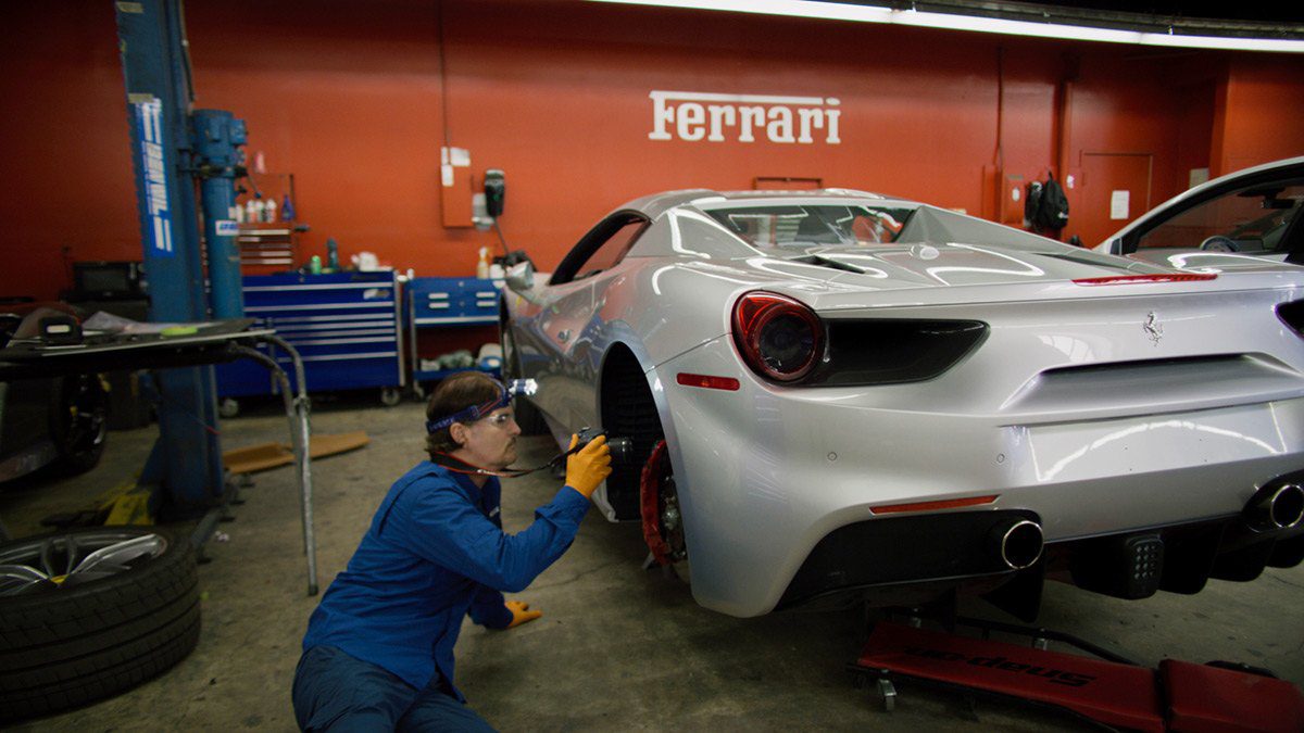 Ferrari-will-need-diminished-value-appraisal Mechanic working on a gray ferrari prior to diminished value appraisal