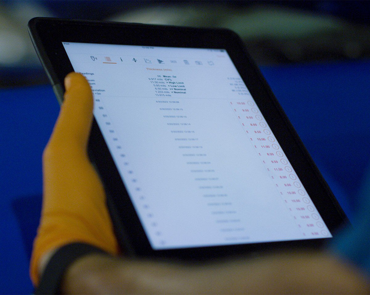 Tablet-displaying-diminished-value-calculator Close up of a hand holding an electronic tablet displaying a diminished value calculator